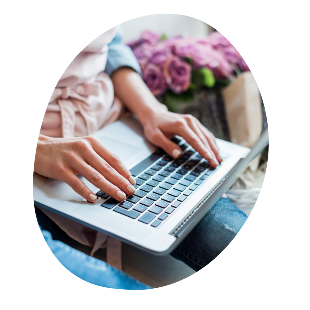 Photo of a person with a laptop on their lap, typing